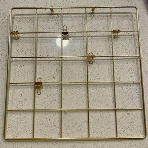 All gold vision board with clips and place to screw in the wall.